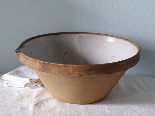 French antique ceramic mixing bowl pictured with antique linen