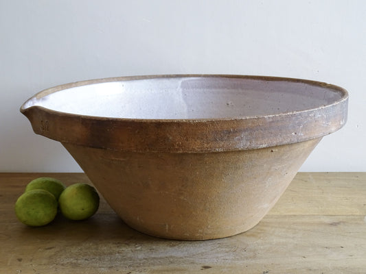 French vintage ceramic mixing bowl from Pérignac, Charente, stamped by a regional pottery workshop. This vintage terracotta bowl has a pale glazed interior and pouring lip.