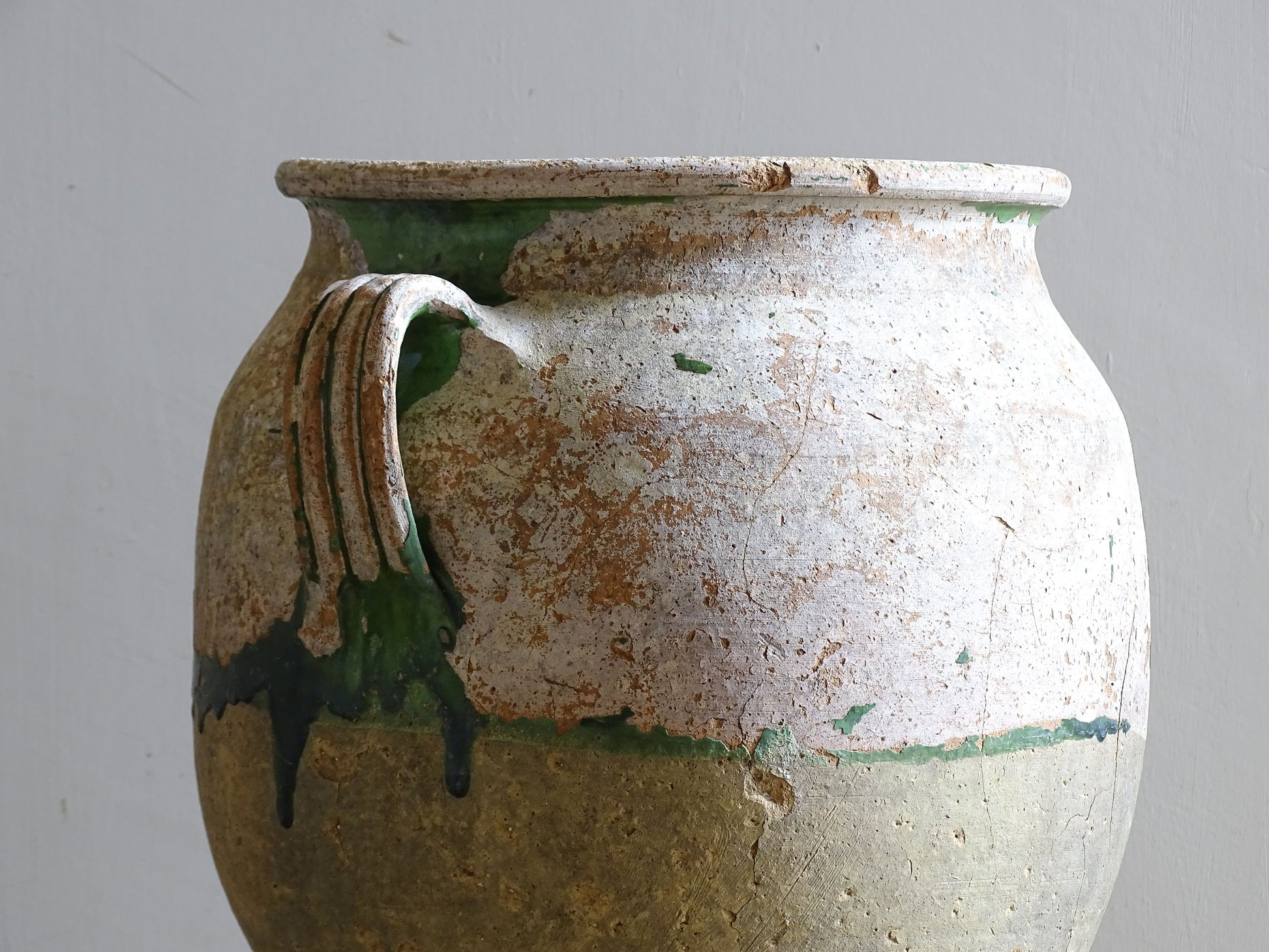 A French antique confit pot from the South West of France, dating to the early to mid 19th century. Hand-thrown in terracotta, the pot has a classic, gently tapered form with two loop handles and a slightly flared rim. 