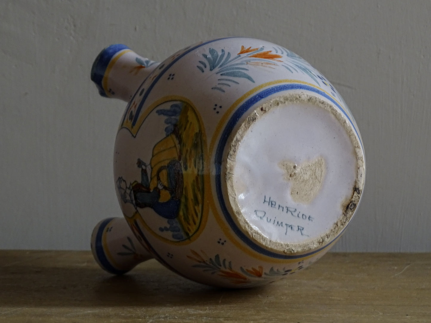 A French vintage tulip vase by Henriot Quimper, featuring traditional Breton decoration and hand-painted detail.
