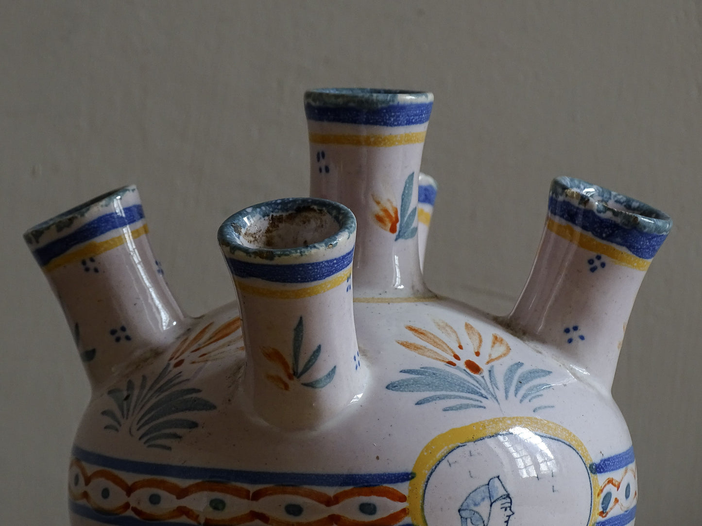 A French vintage tulip vase by Henriot Quimper, featuring traditional Breton decoration and hand-painted detail.