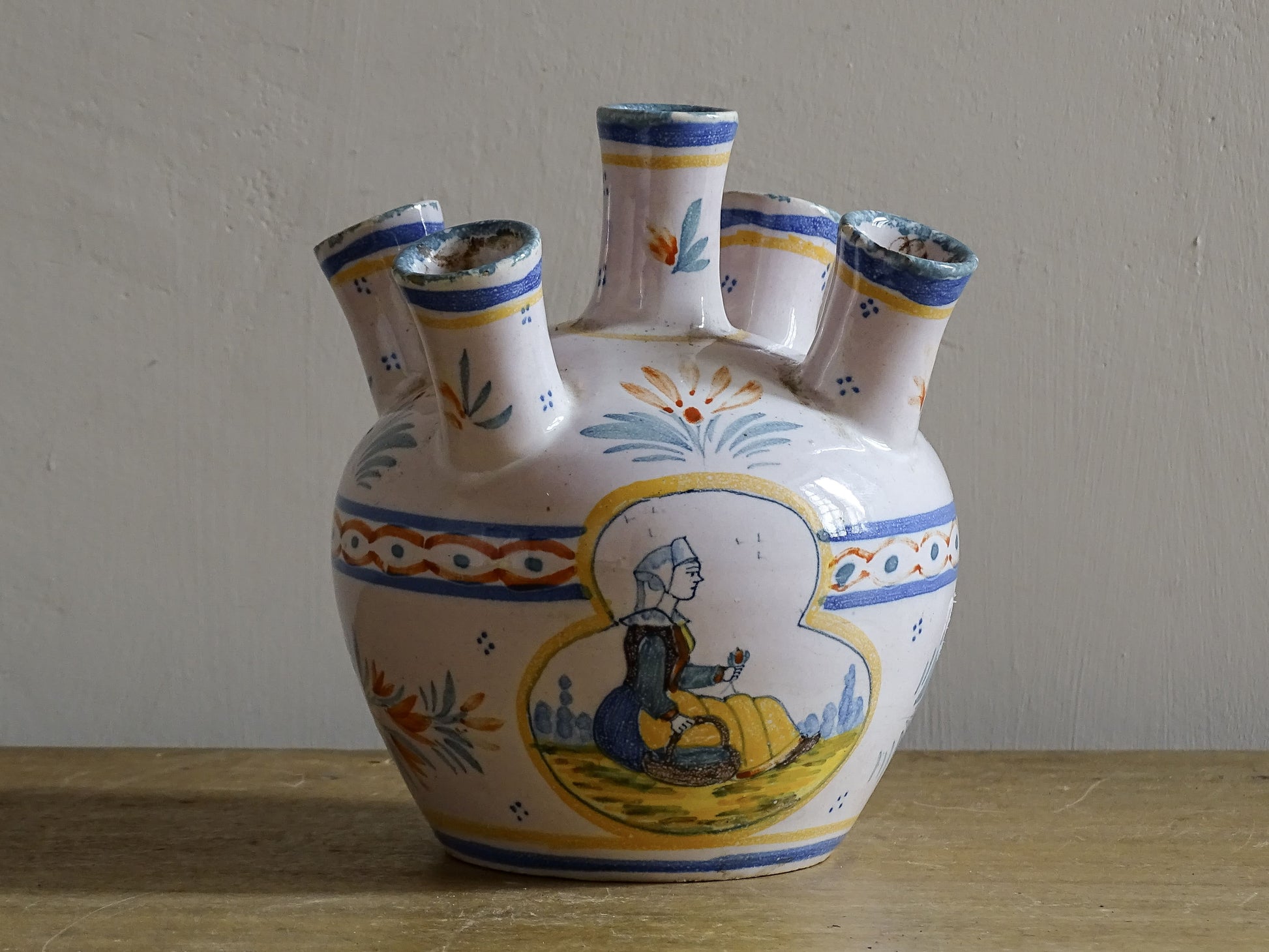 A French vintage tulip vase by Henriot Quimper, featuring traditional Breton decoration and hand-painted detail.