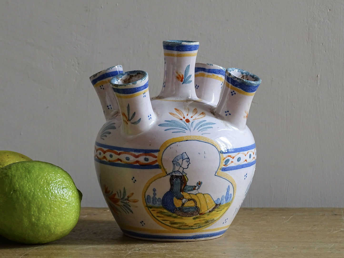 A French vintage tulip vase by Henriot Quimper, featuring traditional Breton decoration and hand-painted detail.