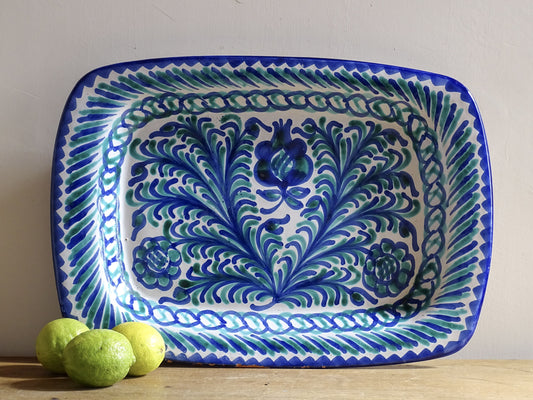 A striking Spanish vintage Fajalauza platter, hand-painted in cobalt blue and soft green on a white ground. The design features flowing foliate motifs and stylised floral details.