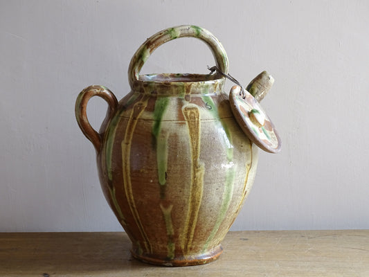 A French antique ceramic water jug or gargoulette from the South of France, dating to the late 19th century. This French antique gargoulette is formed in terracotta and finished with a flowing green and yellow glaze.