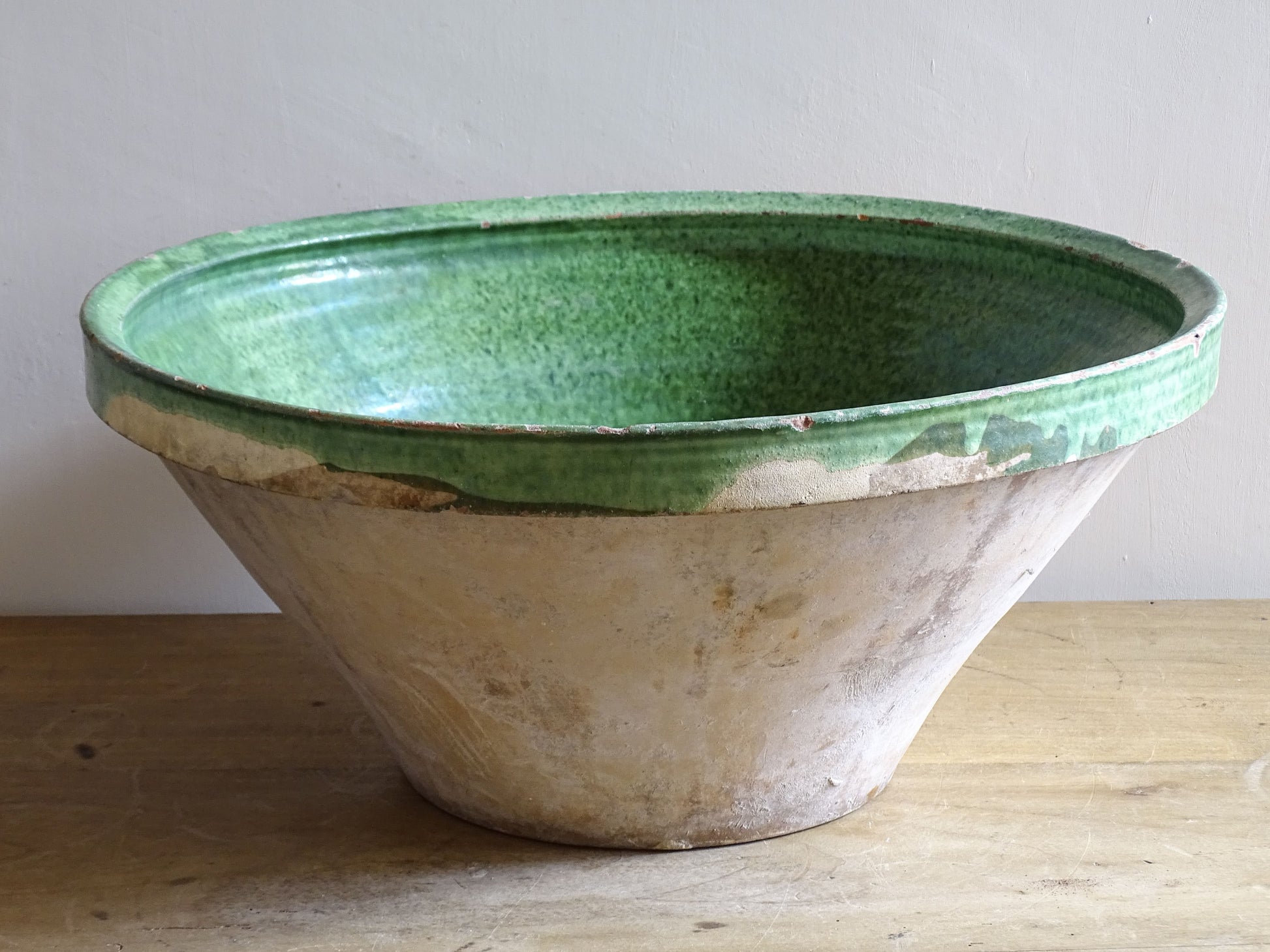 A large antique French tian bowl with a deep green glazed interior, hand-thrown in terracotta. Dating to the late 19th to early 20th century.