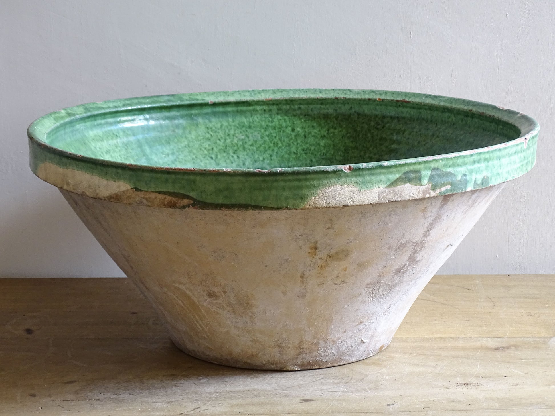 A large antique French tian bowl with a deep green glazed interior, hand-thrown in terracotta. Dating to the late 19th to early 20th century.
