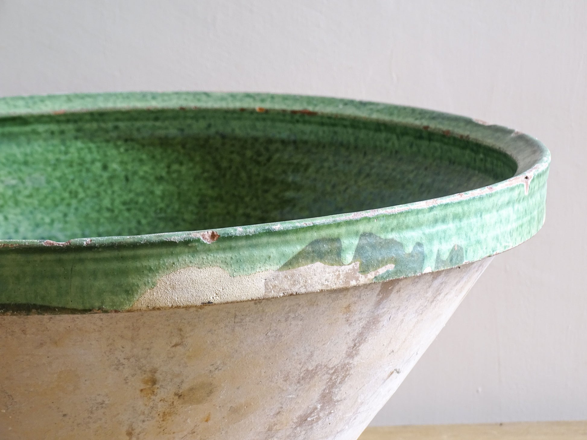A large antique French tian bowl with a deep green glazed interior, hand-thrown in terracotta. Dating to the late 19th to early 20th century.