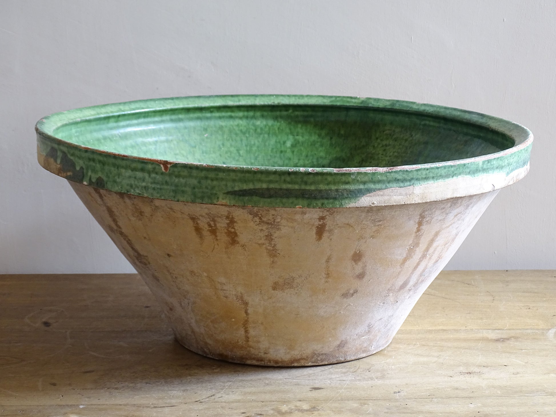 A large antique French tian bowl with a deep green glazed interior, hand-thrown in terracotta. Dating to the late 19th to early 20th century.