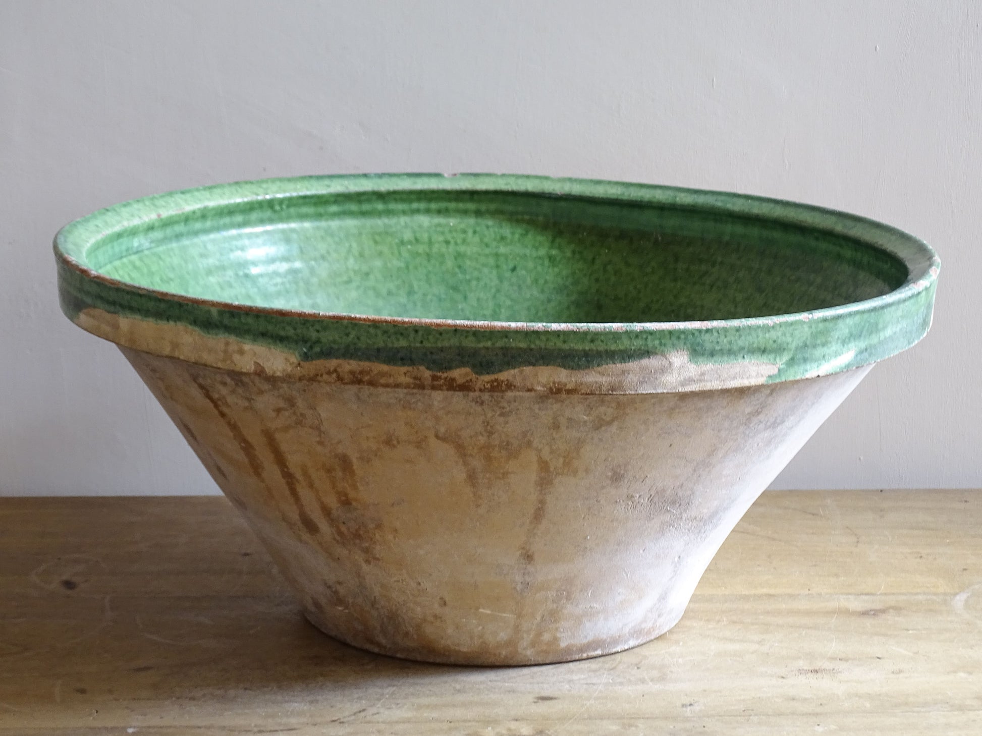 A large antique French tian bowl with a deep green glazed interior, hand-thrown in terracotta. Dating to the late 19th to early 20th century.