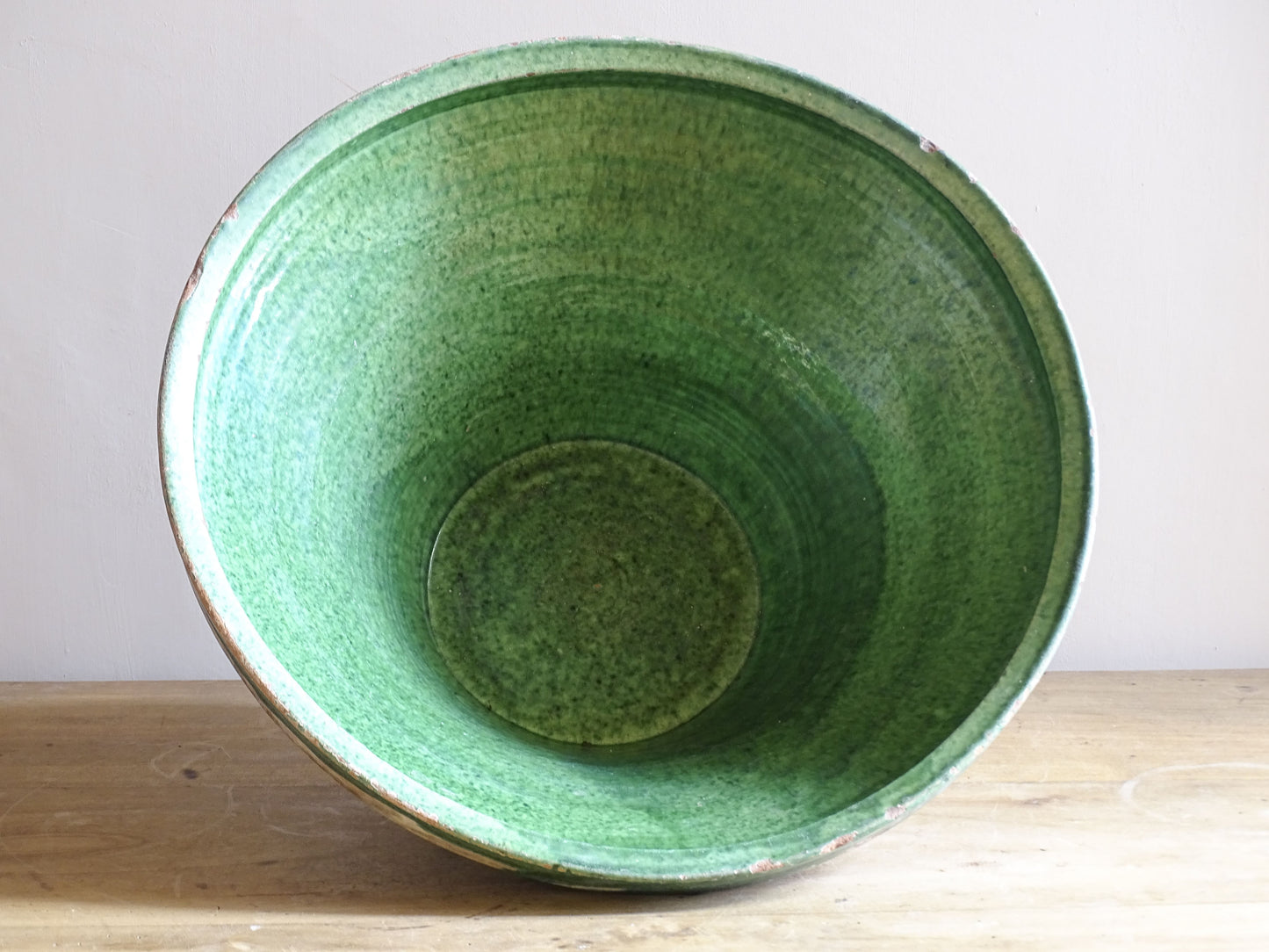 A large antique French tian bowl with a deep green glazed interior, hand-thrown in terracotta. Dating to the late 19th to early 20th century.