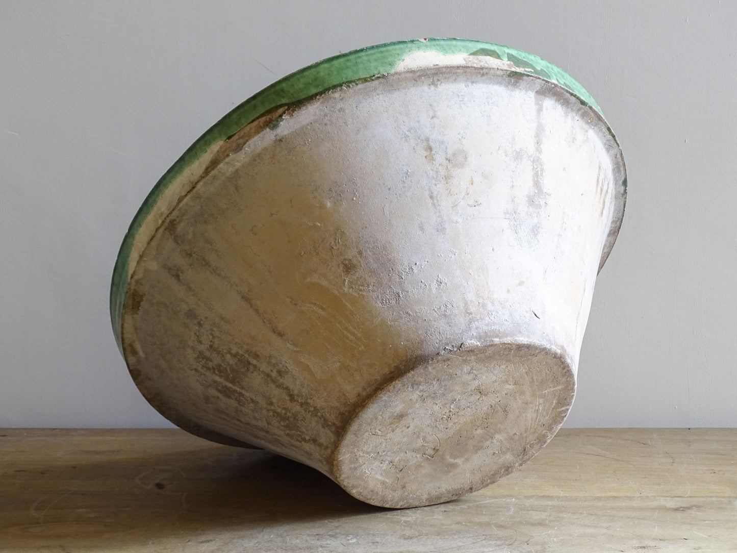 A large antique French tian bowl with a deep green glazed interior, hand-thrown in terracotta. Dating to the late 19th to early 20th century.