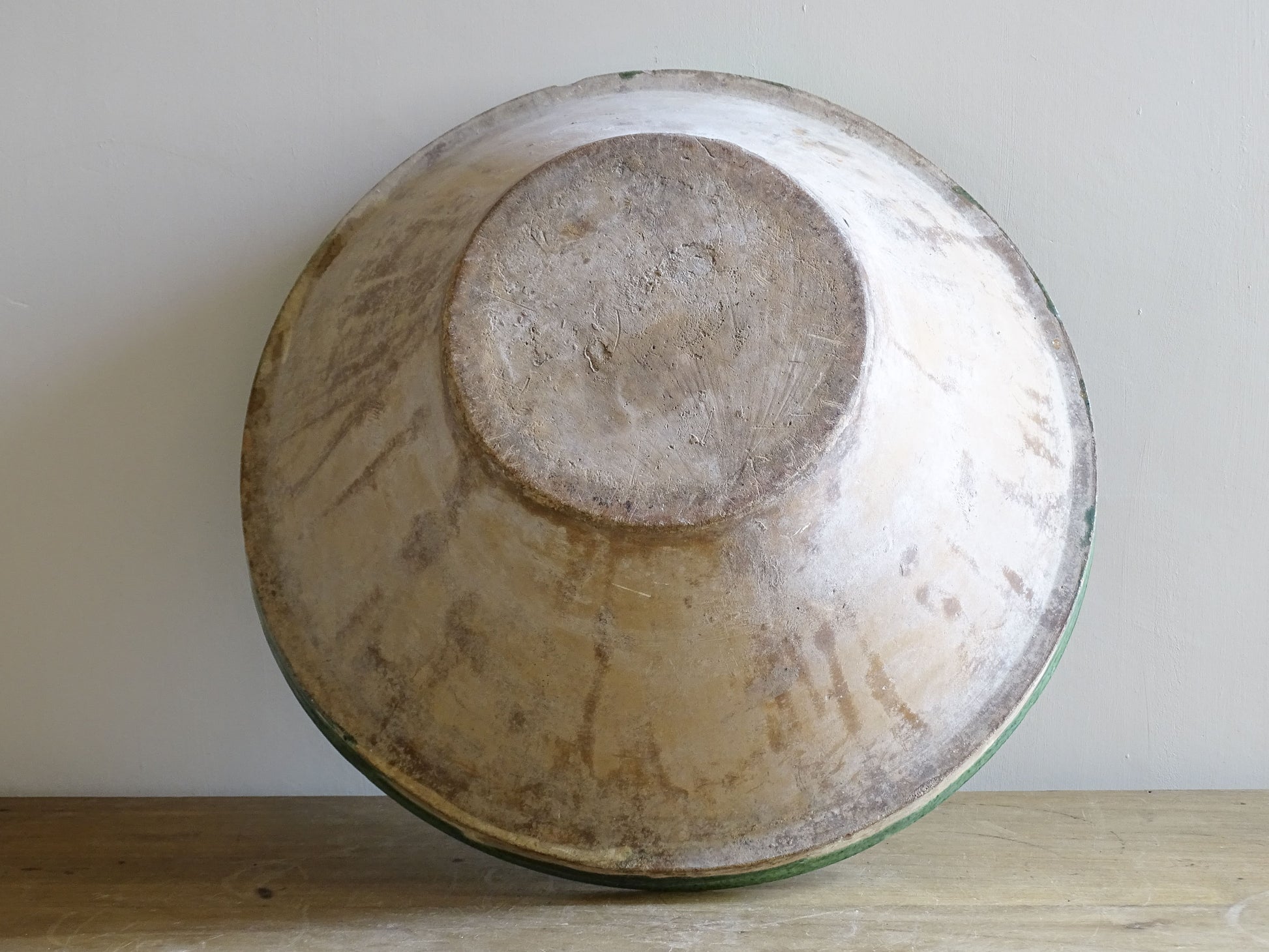 A large antique French tian bowl with a deep green glazed interior, hand-thrown in terracotta. Dating to the late 19th to early 20th century.