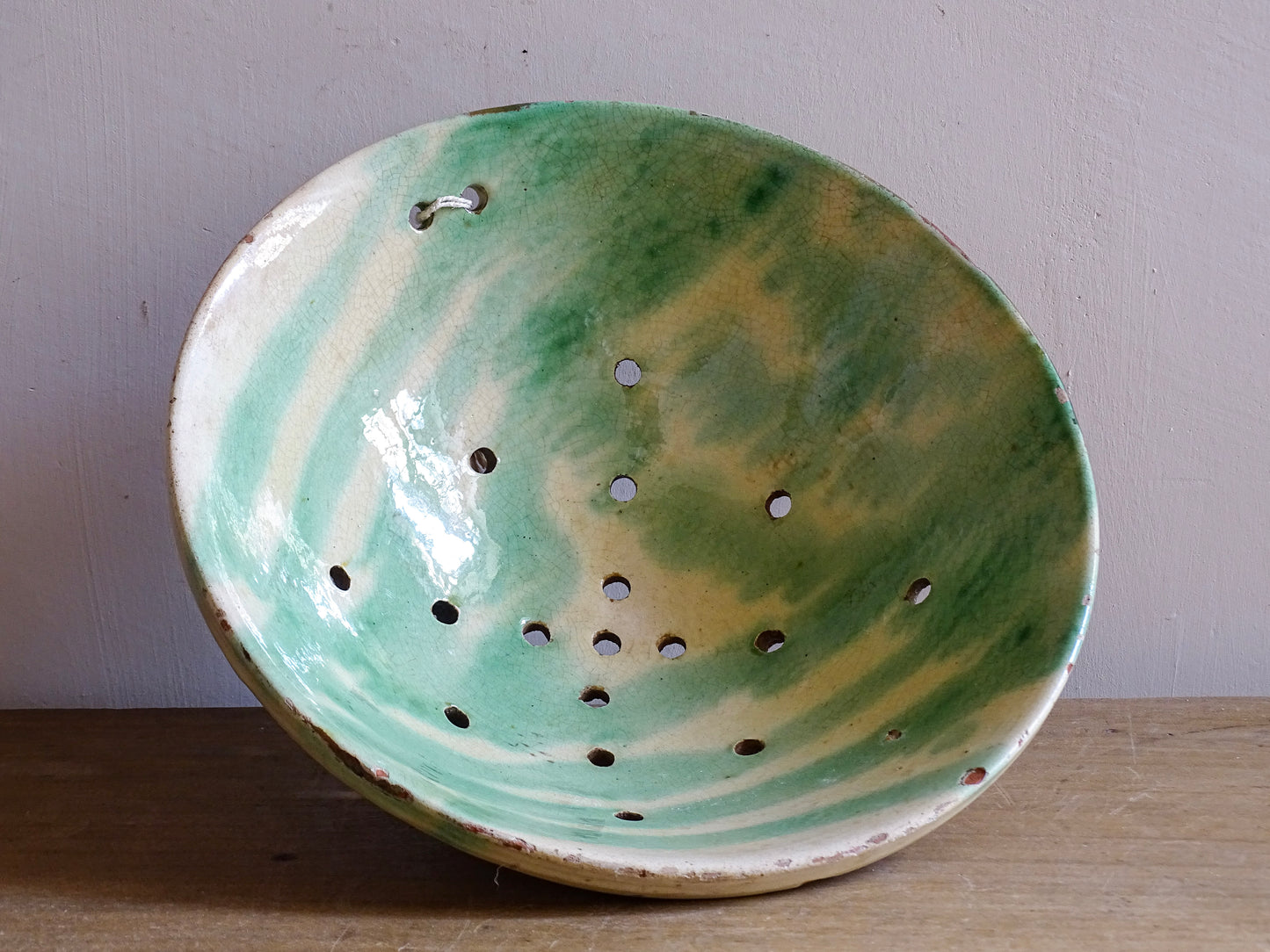 Green glazed French ceramic bowl with rustic worn rim