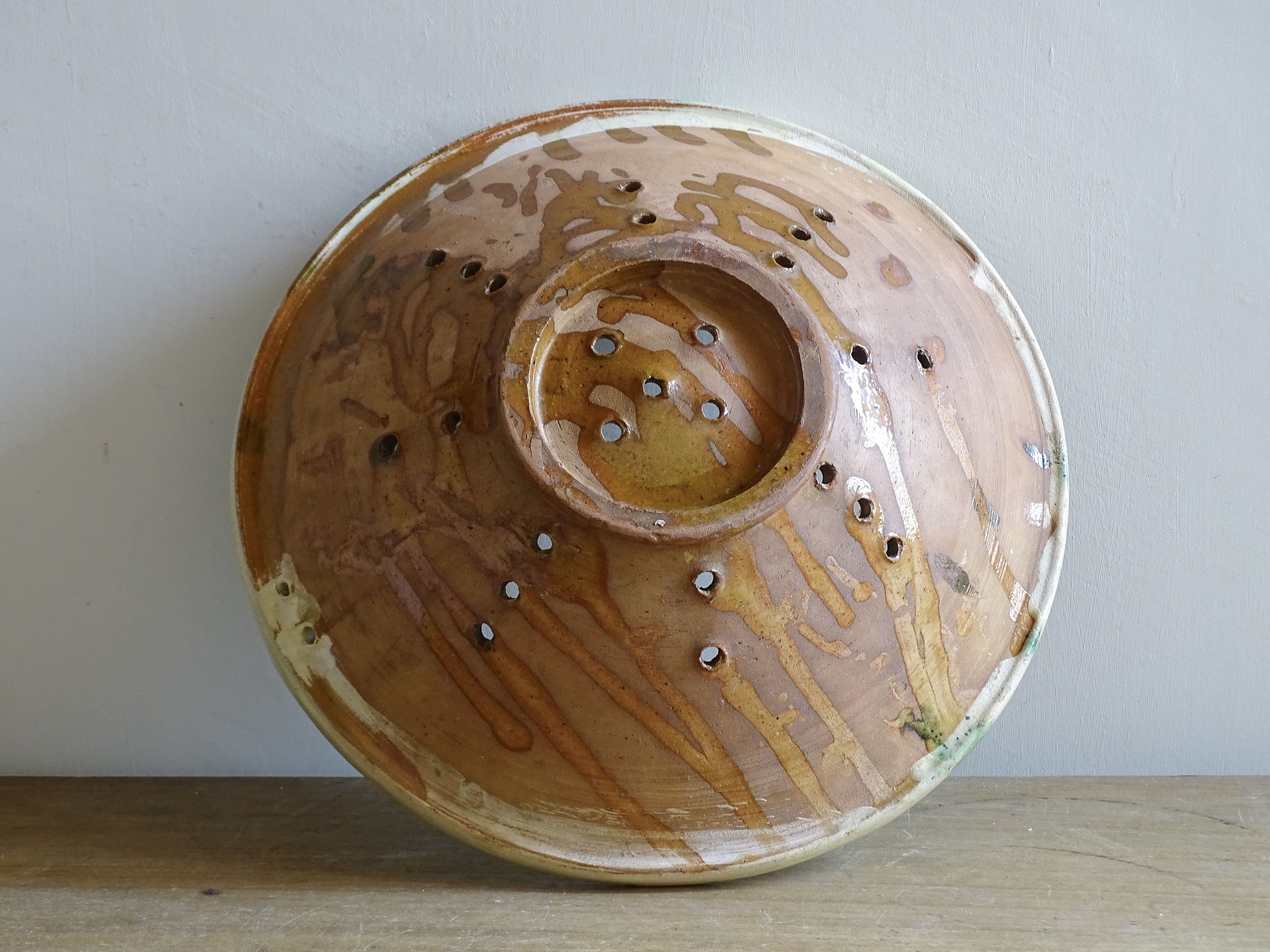 Green and yellow glazed French pottery bowl with worn rim