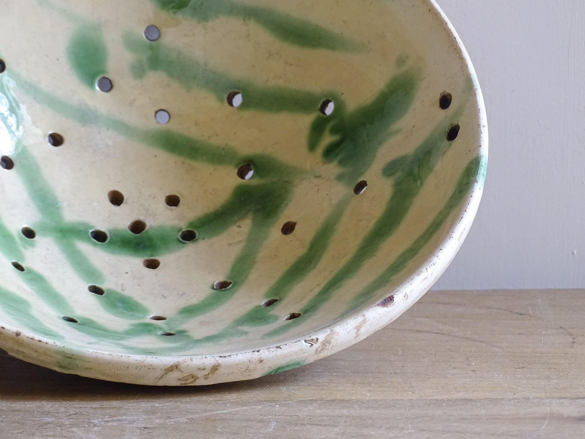 Rustic French pottery colander with pierced drainage holes and foot
