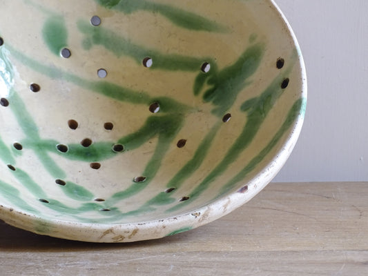 Rustic French pottery colander with pierced drainage holes and foot