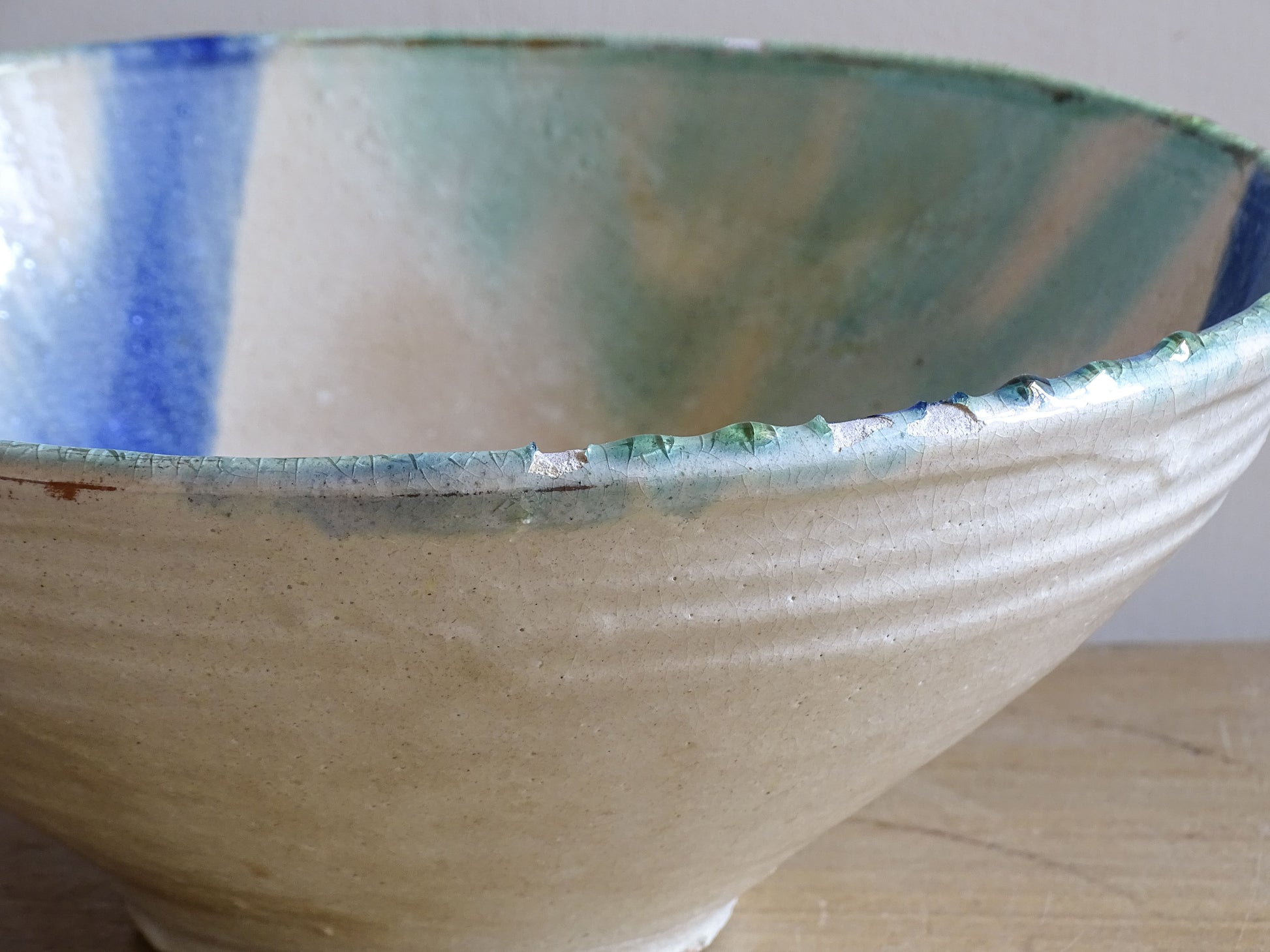 Decorative ceramic bowl with abstract blue and green brushstrokes