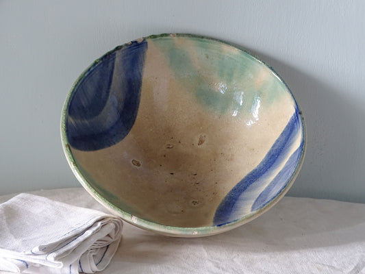French vintage ceramic bowl with blue and turquoise glaze pictured with antique linen