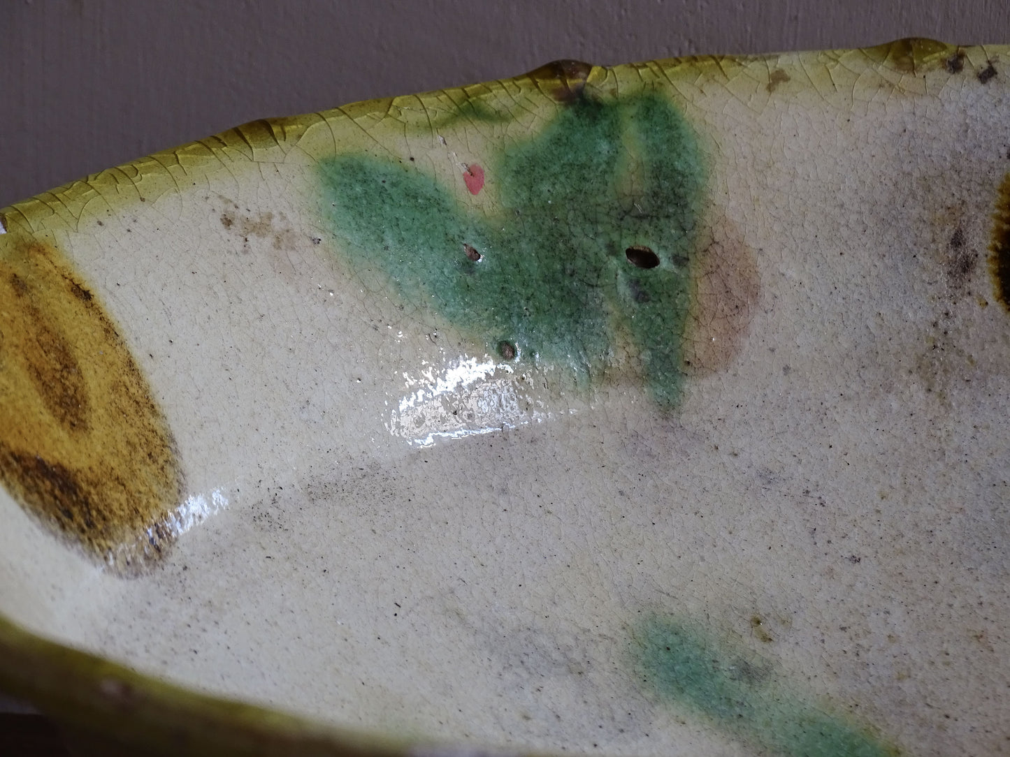 Side profile of French antique earthenware bowl with flared rim and shallow form