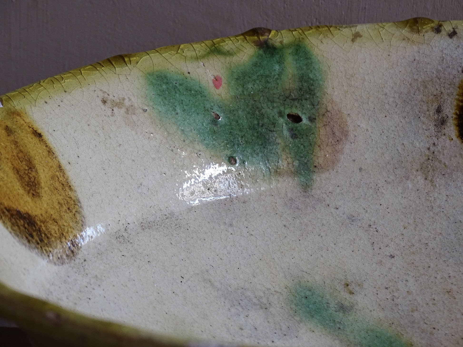 Side profile of French antique earthenware bowl with flared rim and shallow form