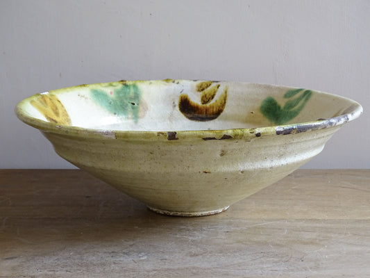 Interior of antique French pottery bowl showing green and brown glaze decoration