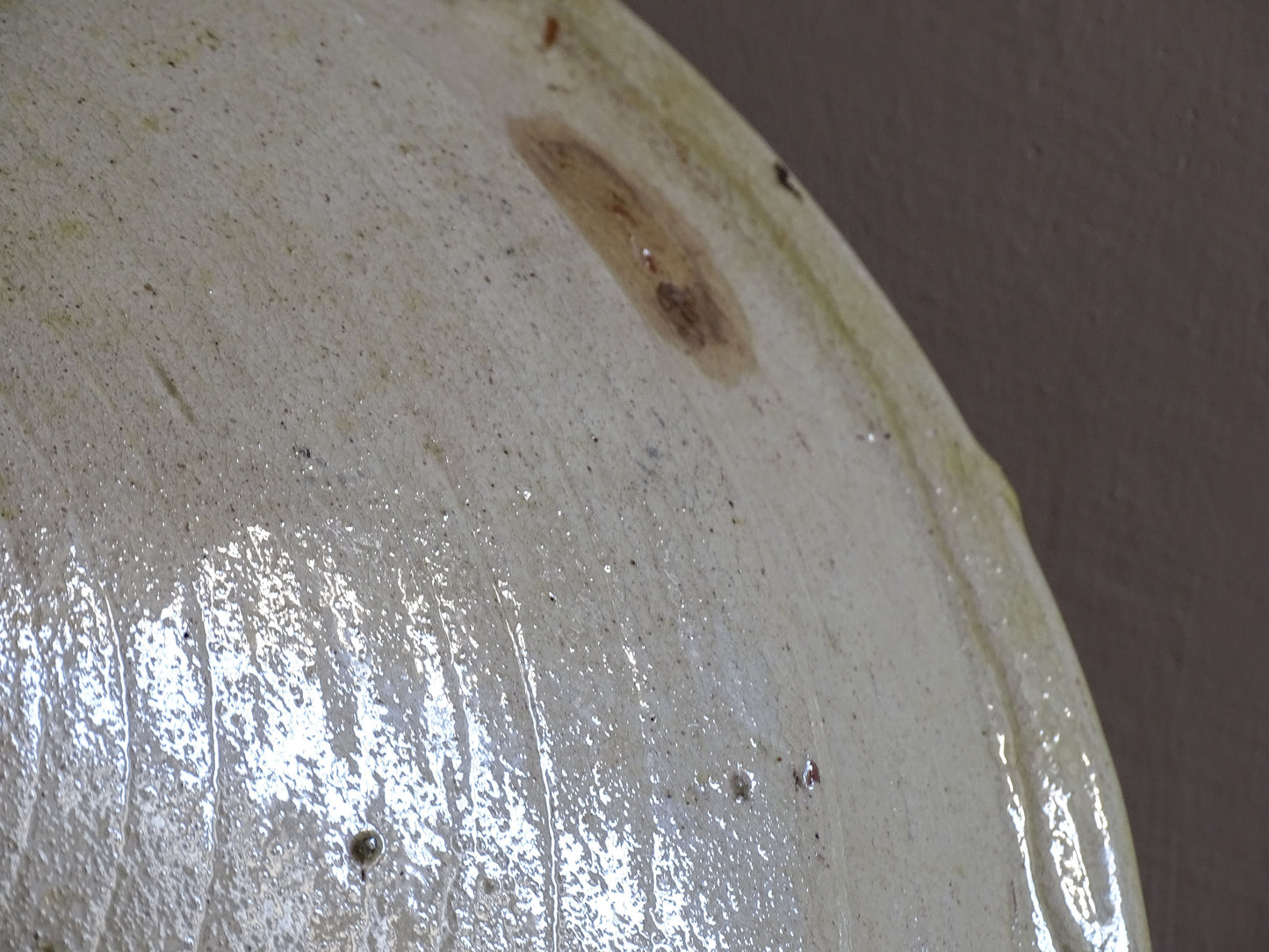 Wide shallow French earthenware serving bowl with rustic glaze and patina