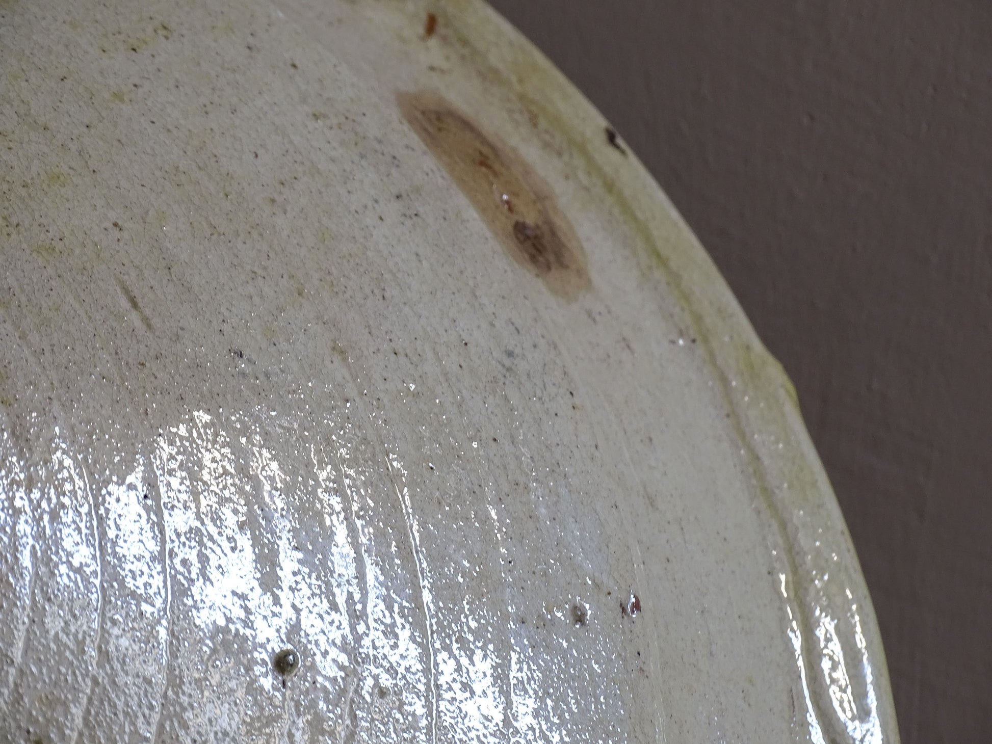 Wide shallow French earthenware serving bowl with rustic glaze and patina