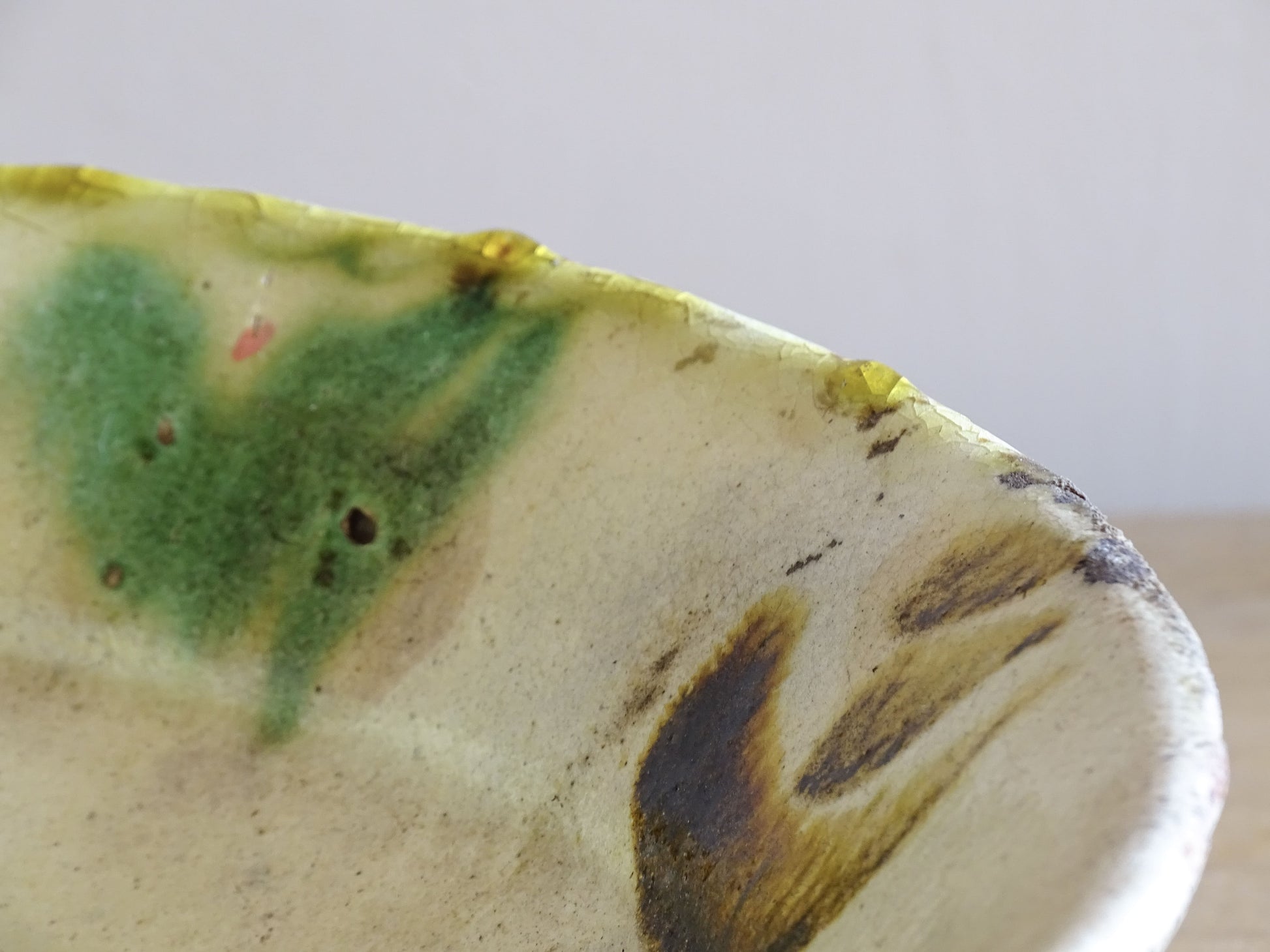 Antique French country kitchen bowl with cream glaze and green brushwork detail
