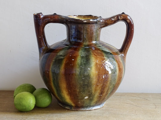 French glazed pottery vessel with twin handles and green ochre striped glaze