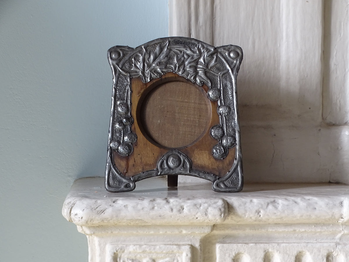 French antique art nouveau photo frame in wood and pewter, pictured on a country house fireplace