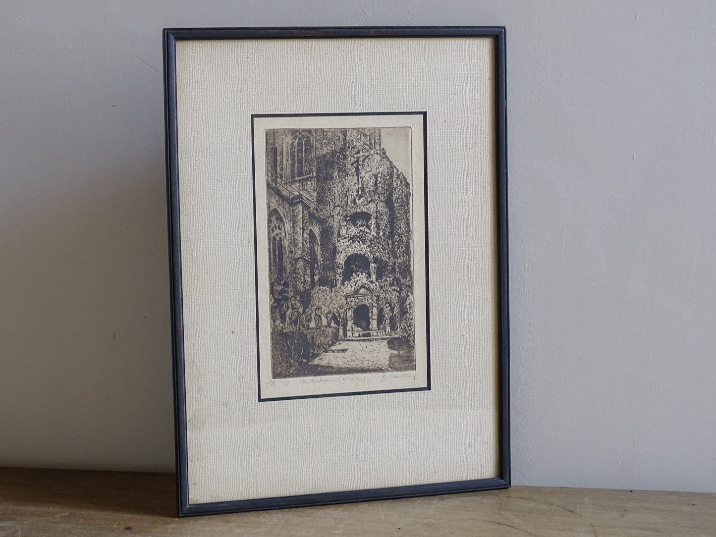 Vintage framed Belgian print depicting a calvary and ecclesiastical courtyard