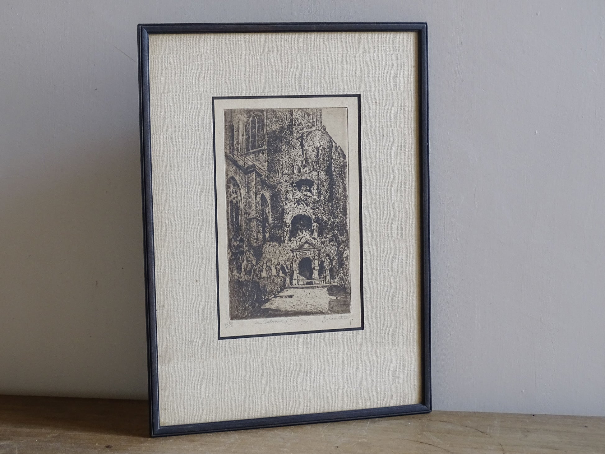 Vintage framed Belgian print depicting a calvary and ecclesiastical courtyard