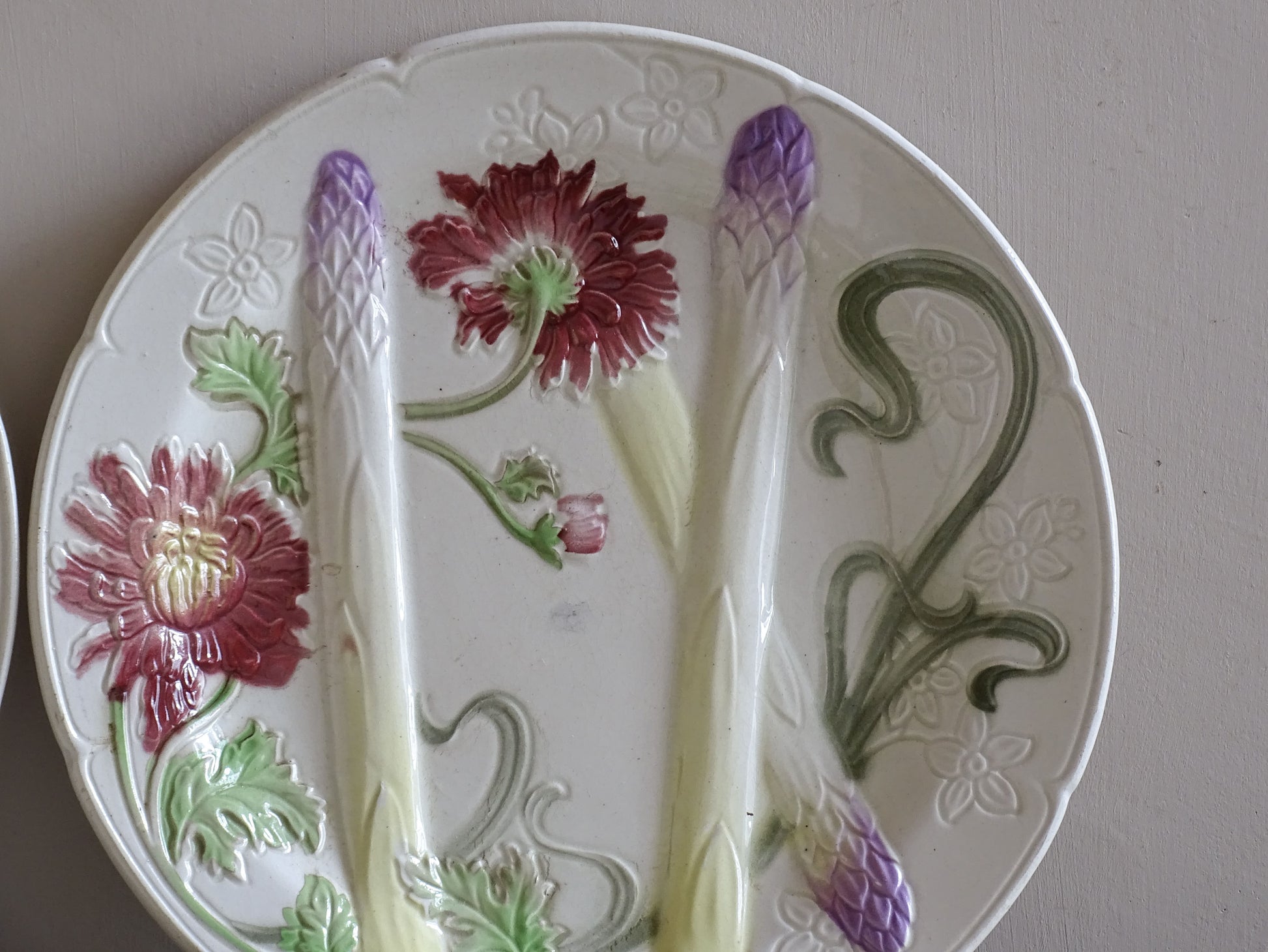 Antique Saint Clément majolica asparagus plate with raised floral decoration