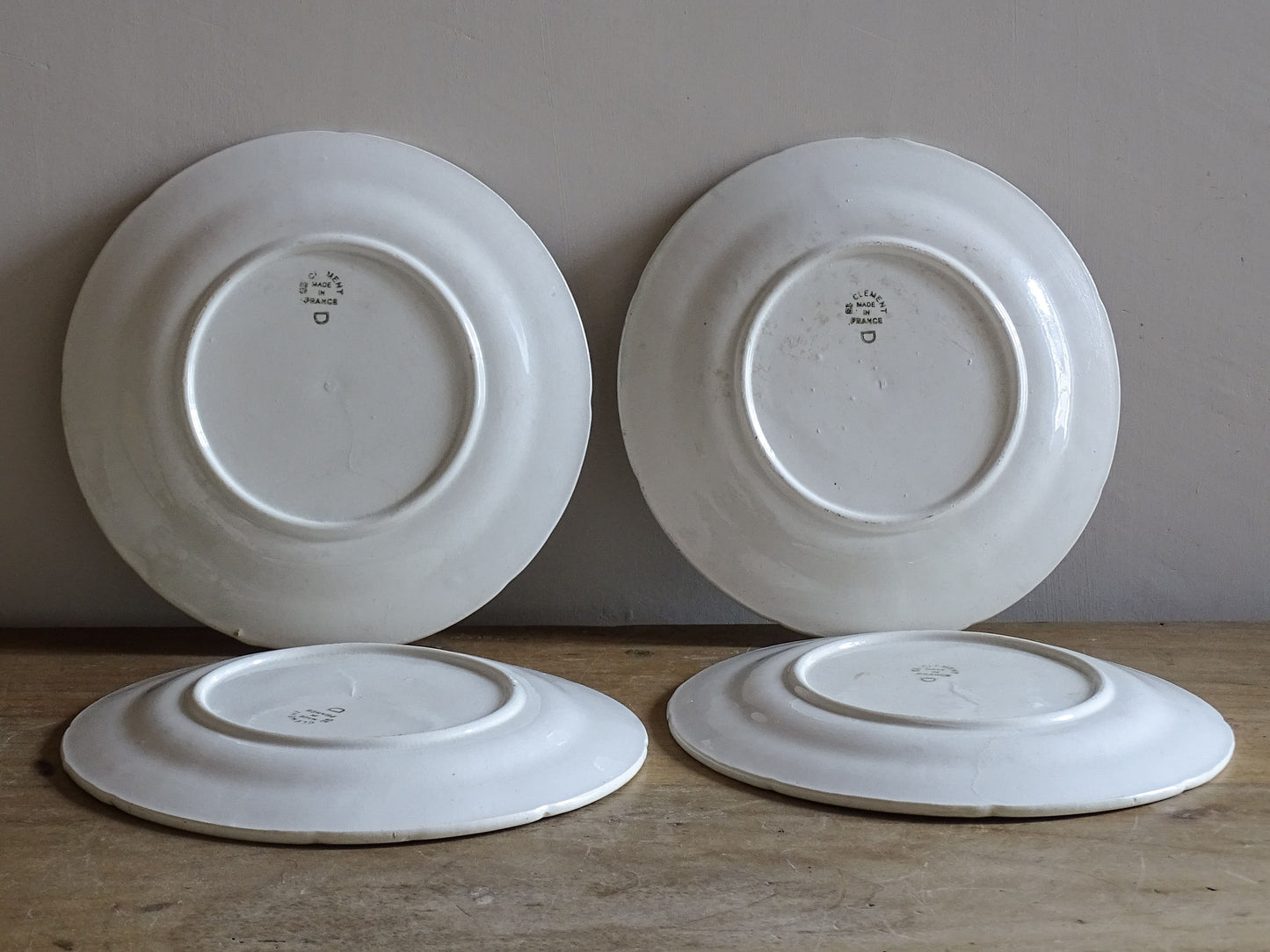 Antique French majolica asparagus plates displayed as a matching set of four