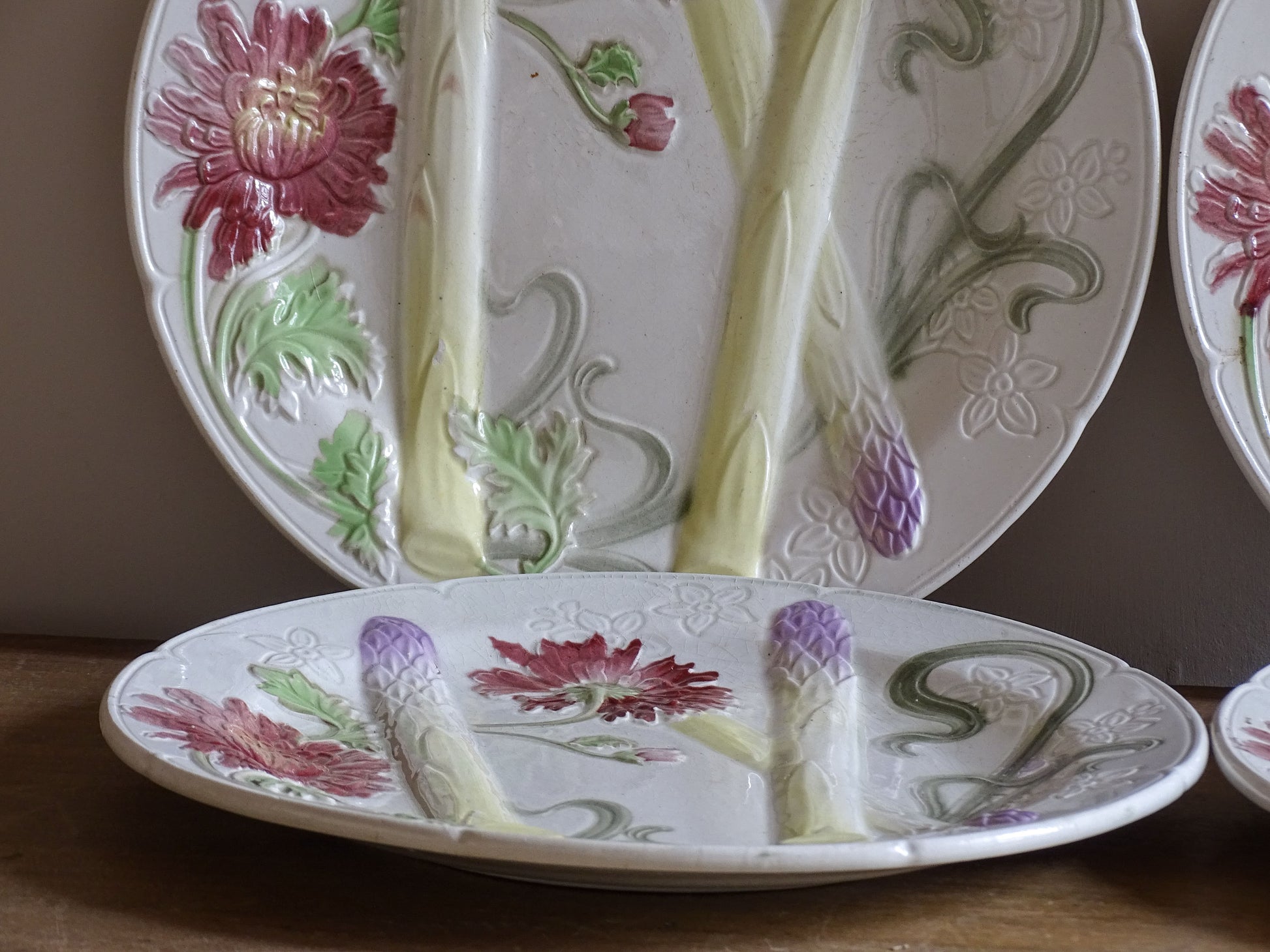 Close view of raised asparagus and floral barbotine decoration on French plate