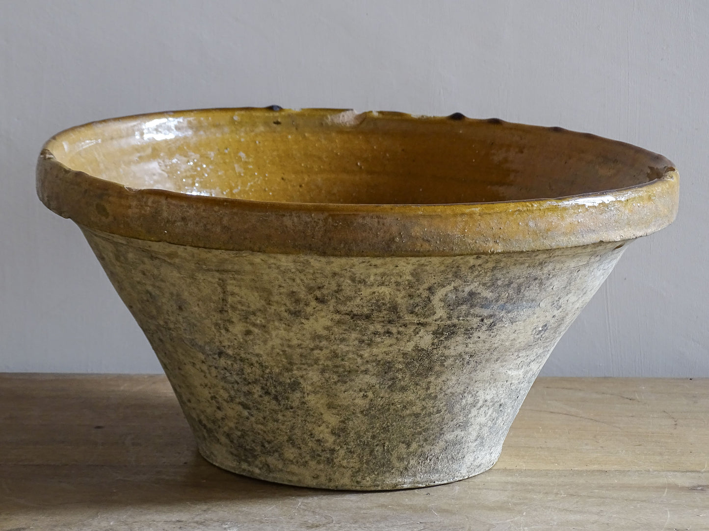 A beautiful French antique tian bowl with a warm mustard yellow glaze and wonderfully timeworn surface. 