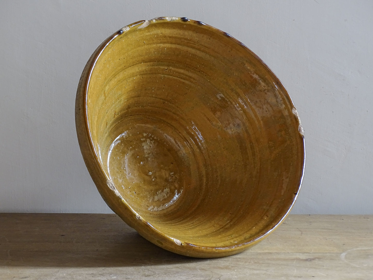 A beautiful French antique tian bowl with a warm mustard yellow glaze and wonderfully timeworn surface. 