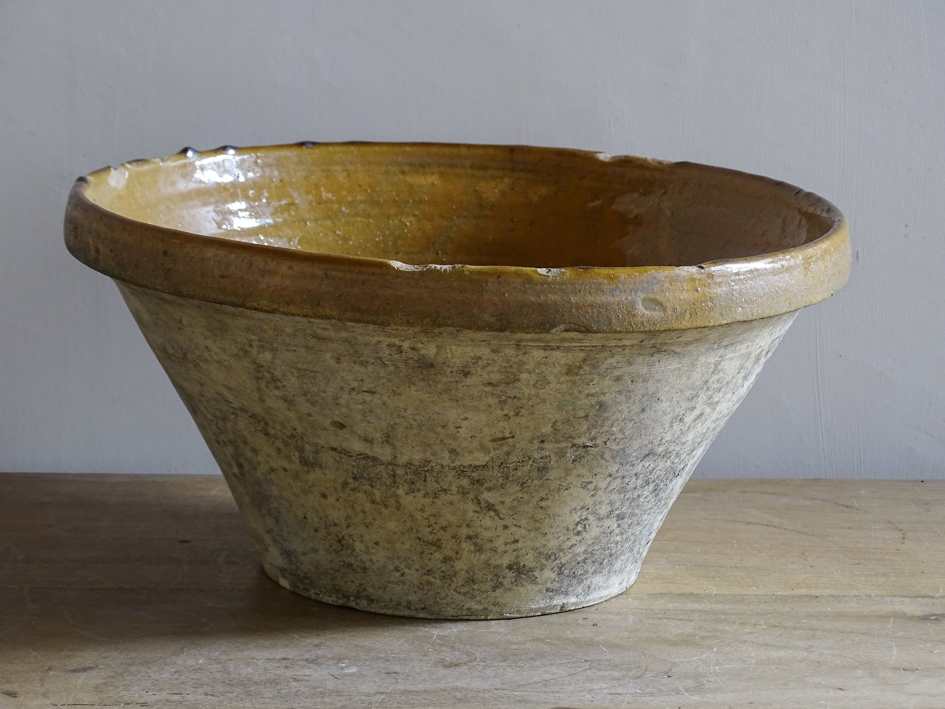 A beautiful French antique tian bowl with a warm mustard yellow glaze and wonderfully timeworn surface. 