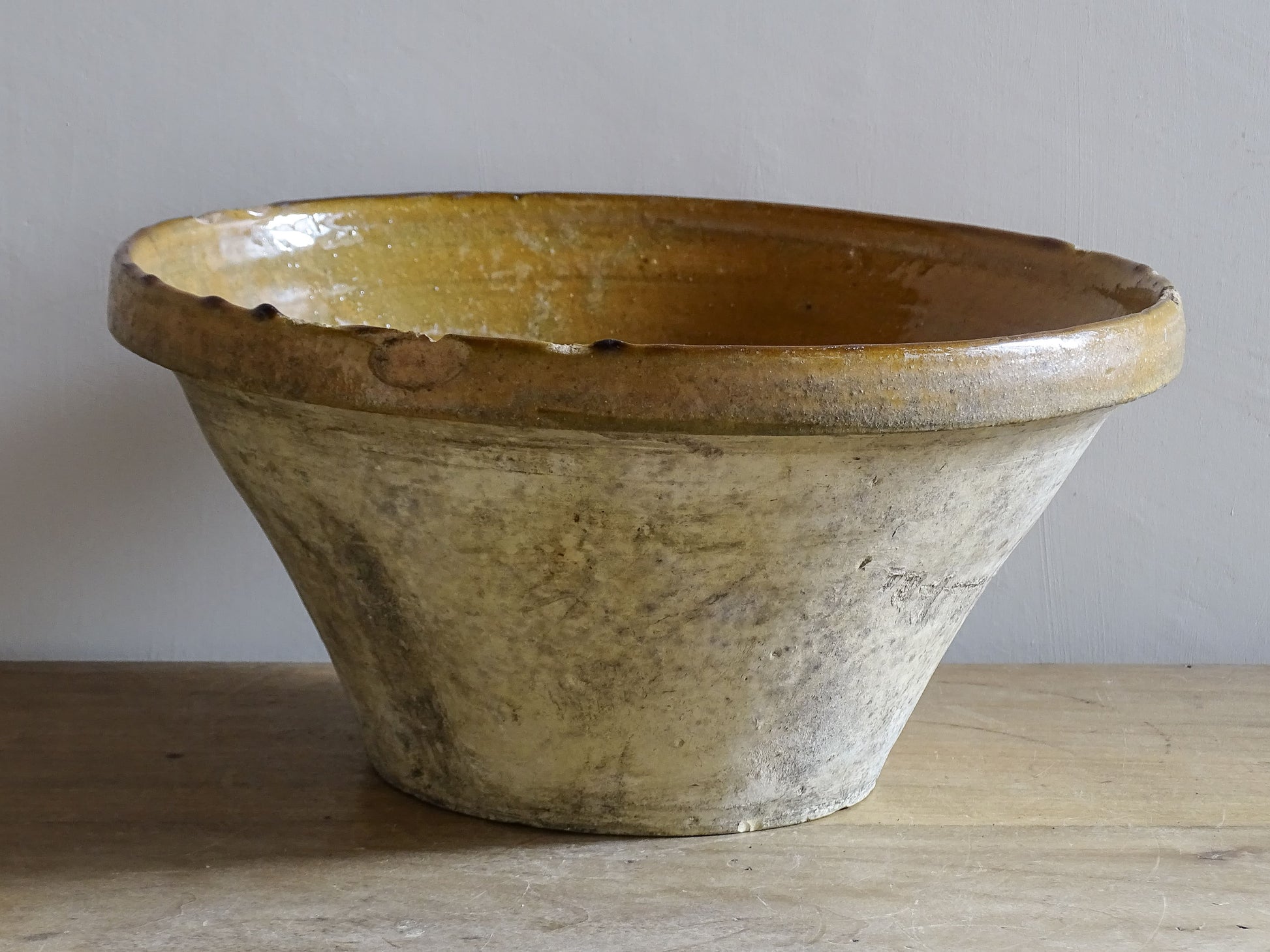 A beautiful French antique tian bowl with a warm mustard yellow glaze and wonderfully timeworn surface. 