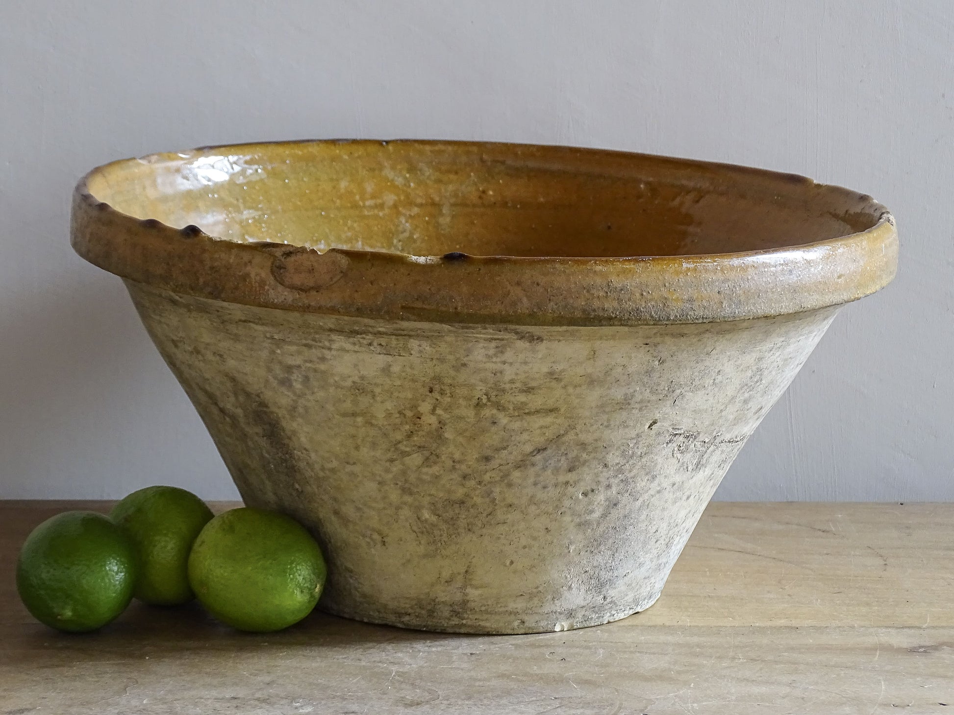 A beautiful French antique tian bowl with a warm mustard yellow glaze and wonderfully timeworn surface. 