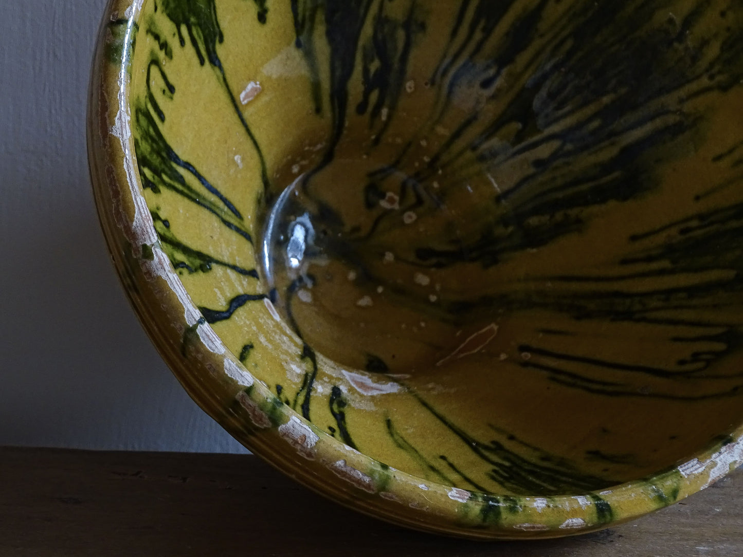  A small French antique terracotta bowl with a striking yellow ochre glaze and a traditional green jaspé decorated interior. Hand-thrown in earthenware.