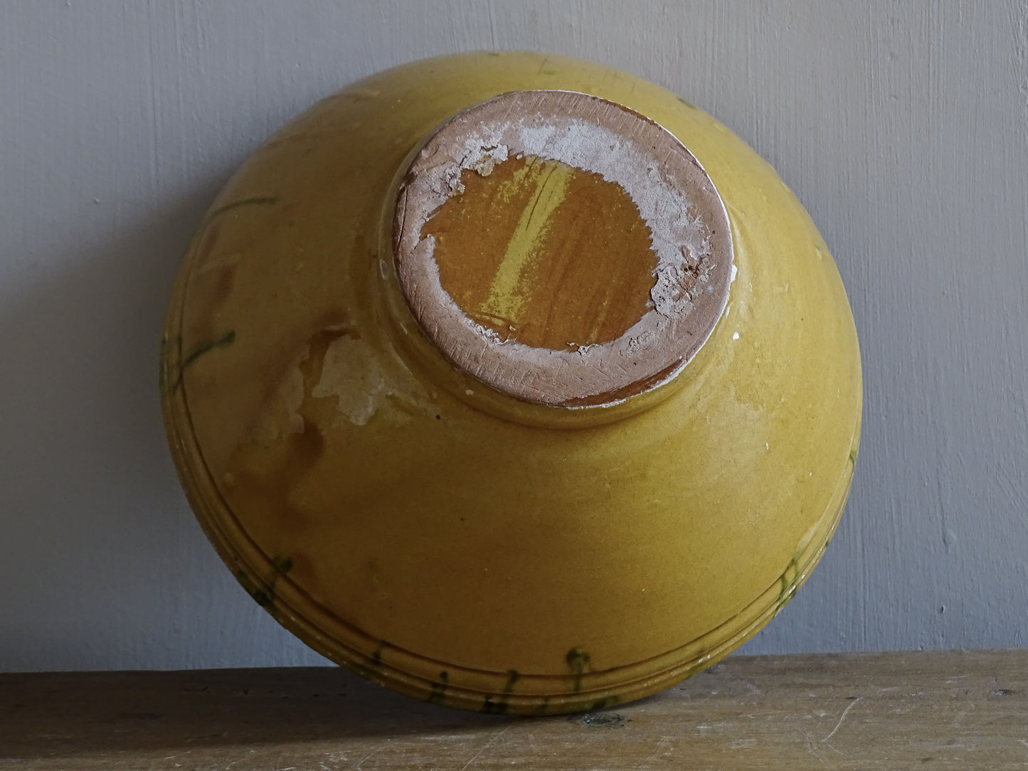  A small French antique terracotta bowl with a striking yellow ochre glaze and a traditional green jaspé decorated interior. Hand-thrown in earthenware.