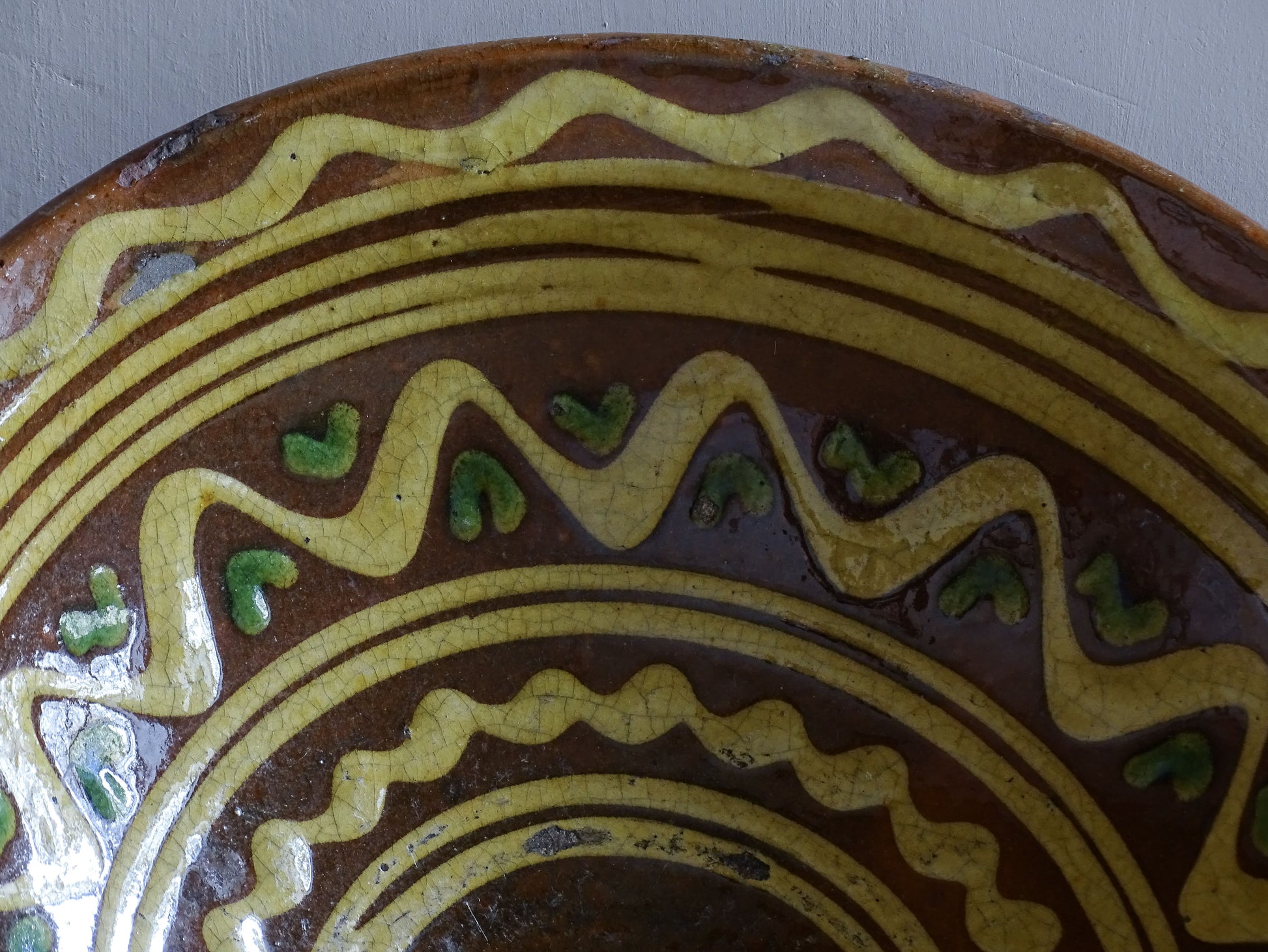 Large rustic French earthenware bowl with yellow and green hand-painted glaze