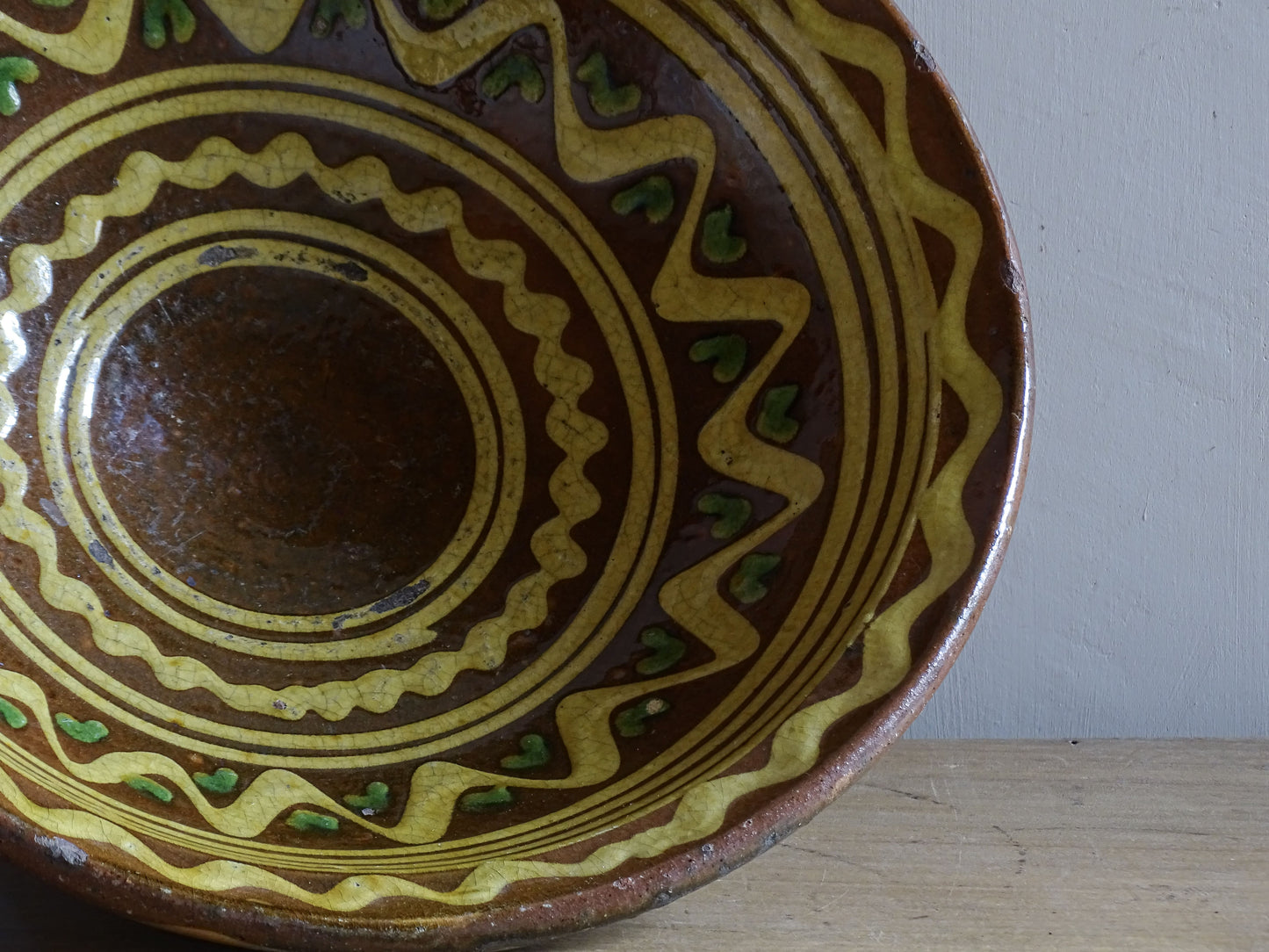 Large antique French glazed terracotta pedestal bowl with rustic slip-trailed design