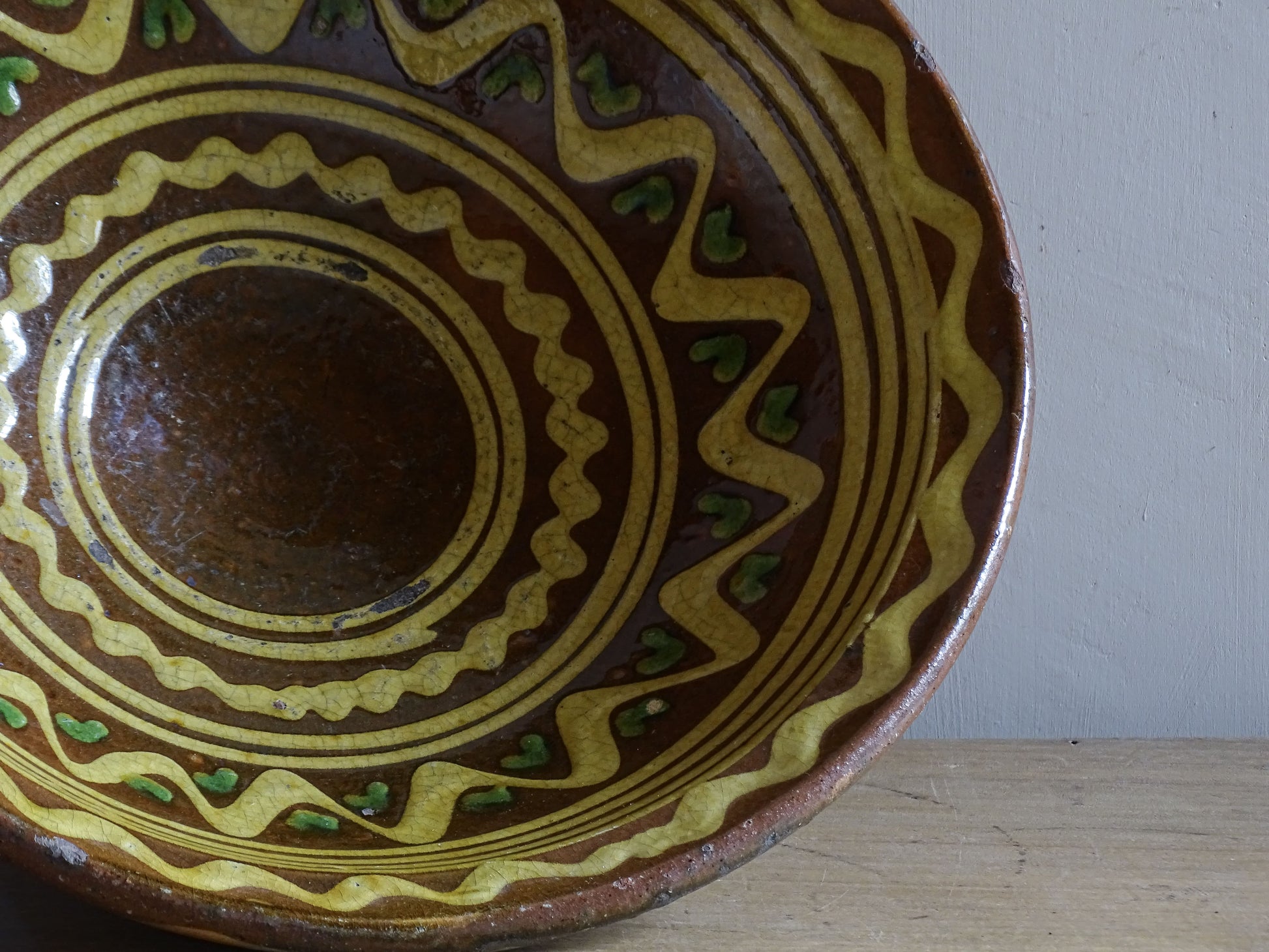 Large antique French glazed terracotta pedestal bowl with rustic slip-trailed design