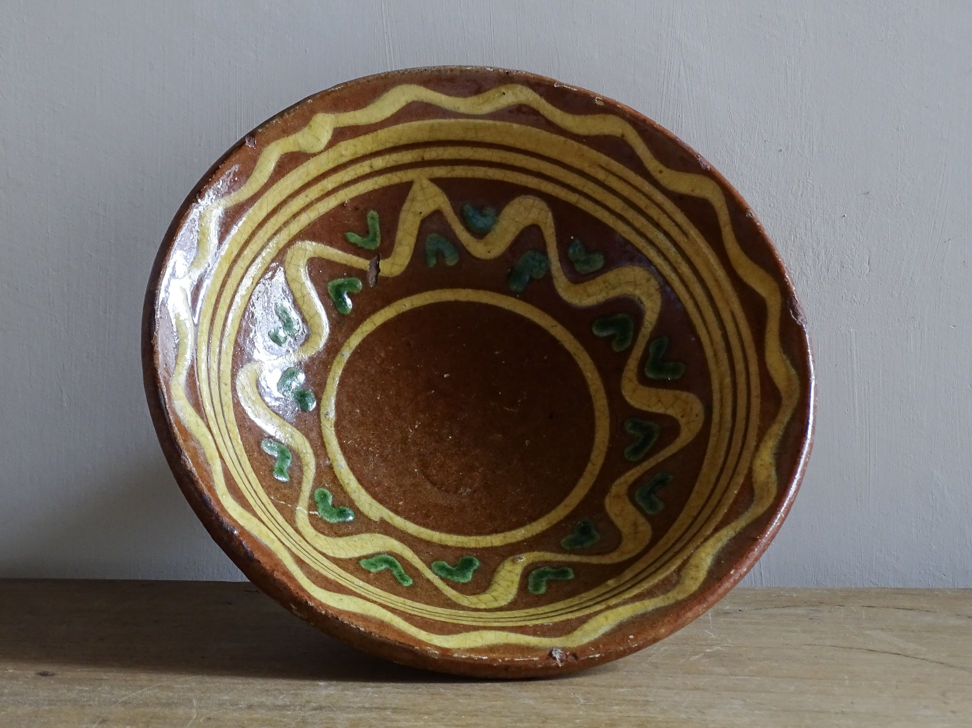 Antique Savoyard pottery coupe on pedestal base with yellow and green glaze details