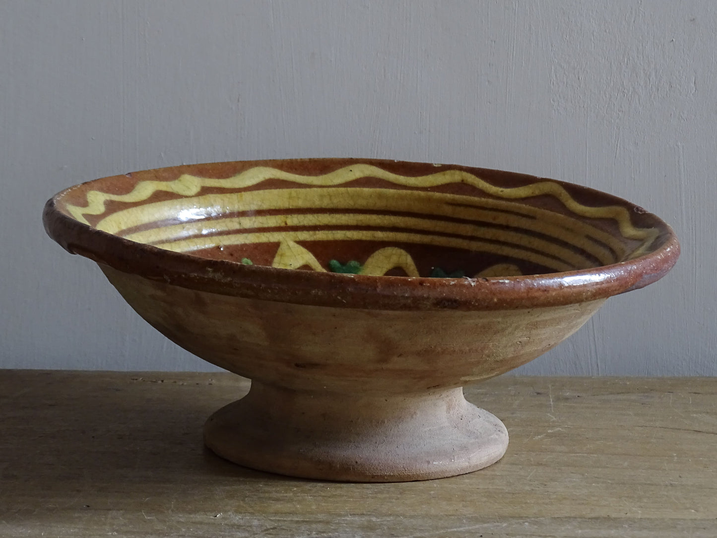 French country interior antique pottery bowl with traditional slip-trailed decoration