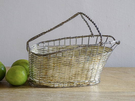 French vintage silver-tone wire wine basket or bottle carrier. It has a woven design and twisted carry handle.