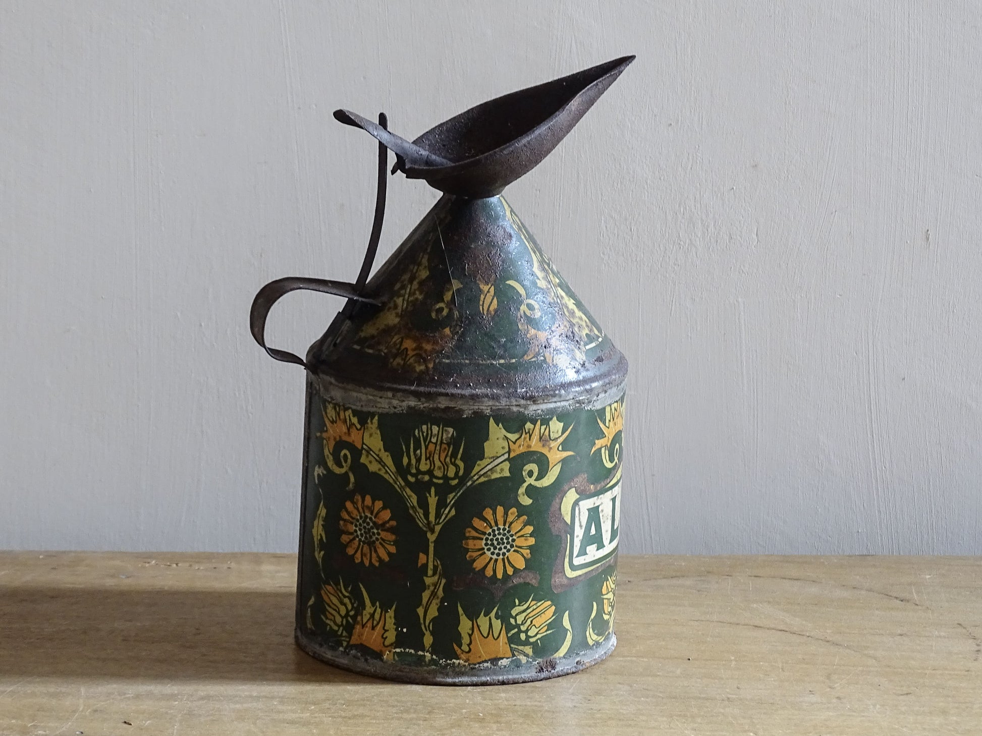 Decorative French lithographed metal alcool can with aged patina